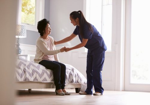 Nurse Making Home Visit To Senior Woman